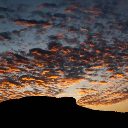 Pedra Branca neighborhood, Palhoca, Brazil with silhouette of the hill, sky at sunset with colorful clouds, infinity of colors in gradient.の写真素材