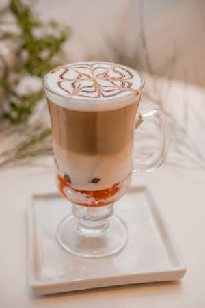 special coffee cup with cream and spices on light background, selective focusの写真素材