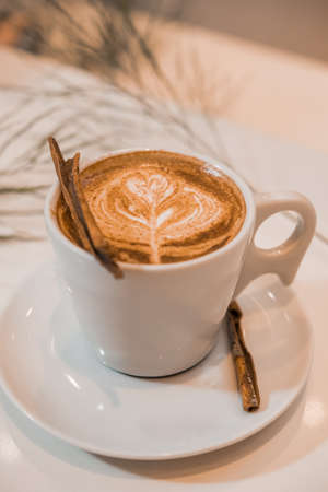 coffee latte art in a clean coffee shop with White cup and selective focusの写真素材
