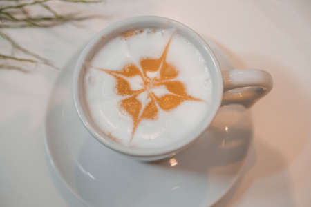 coffee latte art in a clean coffee shop with White cup and selective focusの写真素材