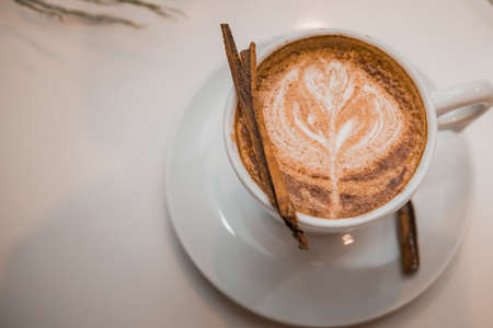 coffee latte art in a clean coffee shop with White cup and selective focusの写真素材
