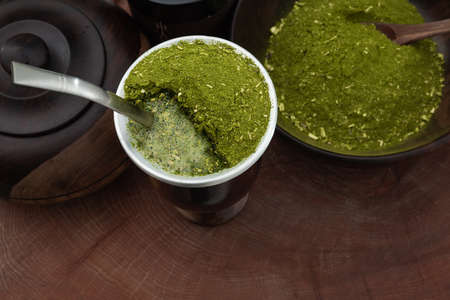 Traditional South American Yerba Mate (chimarrao in Brazil) tea in wooden mate cup with bombilla...