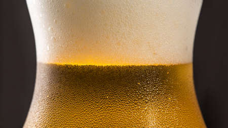 Beer background, with foam drops and sweat, macro close up image