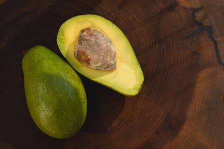 avocado butter, sliced on dark wooden background, copy spaceの写真素材