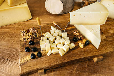 Composition of cheese cubes on a wooden tableの写真素材