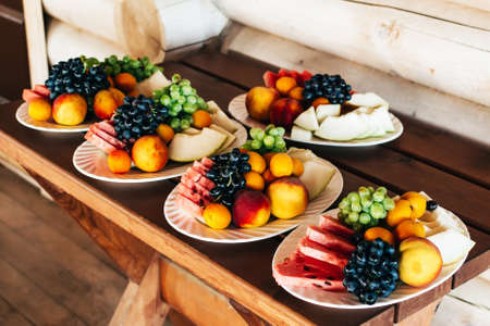 Plates with fruits on a wooden table