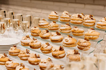 Cakes and champagne on a festive banquet tableの写真素材