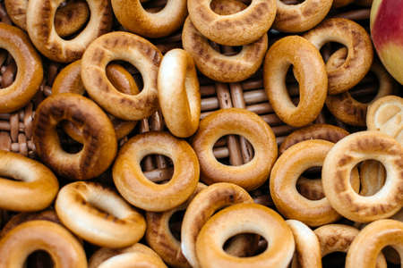 Many bagels in a wicker basket close upの写真素材