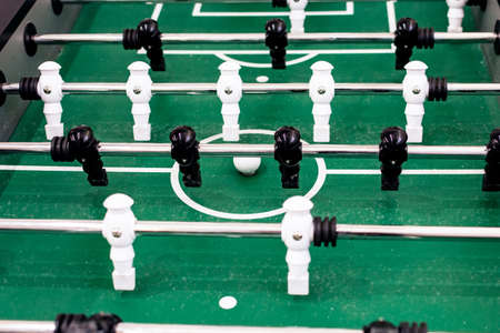 Table football with black and white figures close up