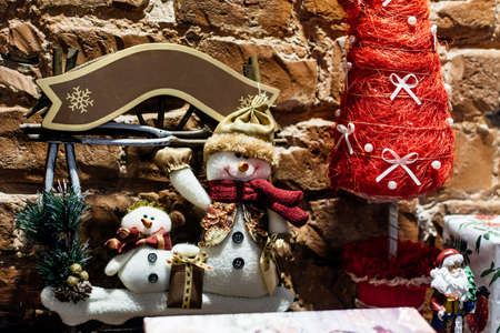 Composition of christmas toys on a brown brick wall background close-upの写真素材