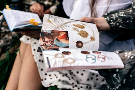 women magazine in women hands in natureの写真素材