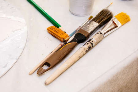 Stationery brushes for needlework on a white tableの写真素材