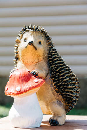 Sculpture of a hedgehog with a mushroom in natureの写真素材