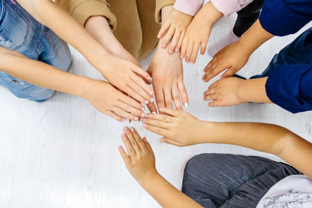 Children hands are joined together in playの写真素材
