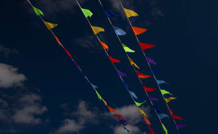 colored flags on a blue sky backgroundの写真素材