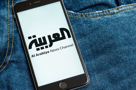 New York / USA - 02/23/2019: Black phone with logo of news media Al Arabiya on the screen. News...