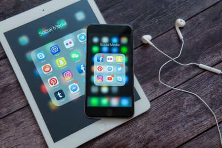 New York / USA - 04/12/2019: Apple iPad and iPhone with icons of social media: instagram, youtube,...