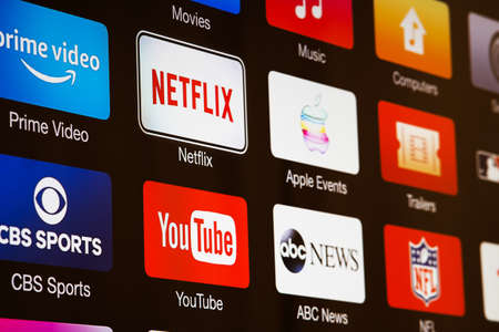 Miami / USA - March 17, 2020: Smart TV with icons of  video streaming services and apps: YouTube, ABC News, Tastemade, UFC, NFL, Crunchyroll, Flickr and Red Bull TV. News media on the screenのeditorial素材