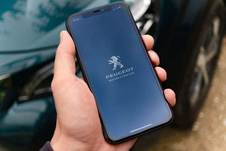 Tallinn / Estonia - 08/30/2020: Black Apple iPhone with international applications of Peugeot...
