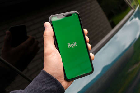 Tallinn / Estonia - September 1, 2020: Black iphone with logo of Bolt application on the screen. Hand with phone. Can be used as illustrative for marketing or business conceptのeditorial素材