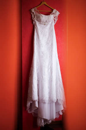 White wedding dress on the red wallの写真素材