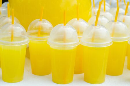 Yellow lemonade plastic cups with tubes and flaresの写真素材