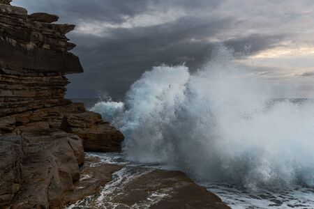 Big waves crashing against the cliffs at Clovelly NSW Australiaの写真素材