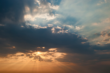 Sunrise sky with god rays and two sides - red and blue, good and bad conceptの写真素材