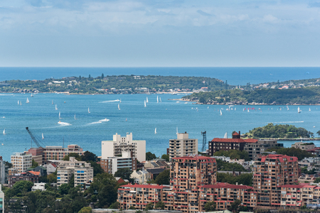 Sydney harbor with ships and yachts and adjacent bulidings from heightの写真素材