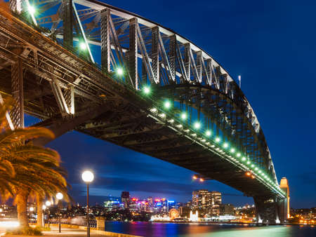Harbor Bridge in Sydney during the night with city lights and dark skyの写真素材