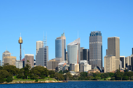 View from water on the sydney cbd with sydney tower and skyscrapers and royal botanic garden with touristsの写真素材