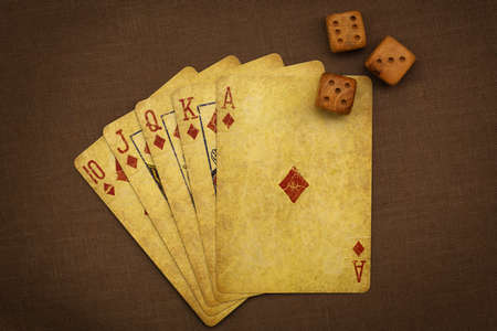 Wonderful poker combination and not-so-bad dice alignment shooted with retro-stuled playing cards and wooden dicesの写真素材