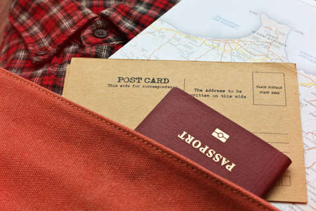 Checkered shirt, map, postcards and passport in retro styled backpackの写真素材