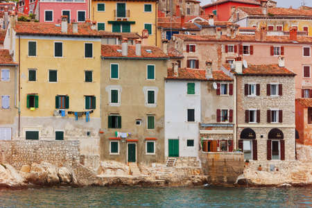 Typical southern europe town with houses standing over the waterのeditorial素材