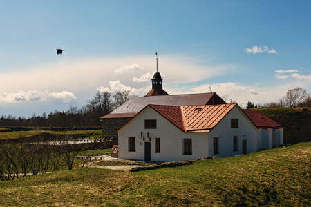 Autumn landscape of well restored fortress with tower and barracks buildingのeditorial素材