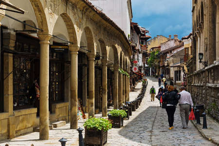 Tourists and holidaymakers walking along the well restored old town street in Veliko Tarnovo, Bulgariaのeditorial素材
