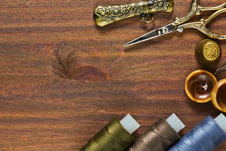 Bronze vintage sewing and handicraft tools on the wooden table
