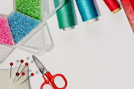 Different colorful tools for handicraft and home sewing works in top flat viewの写真素材