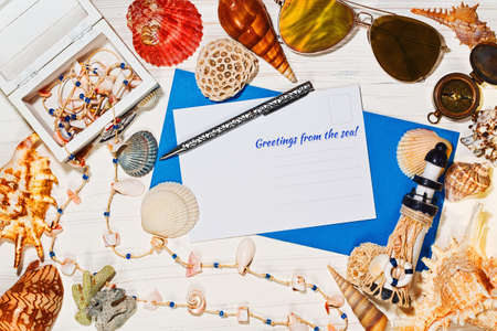 Vacations mediterranean style concept - postcard and envelope, lighthouse and souvenir box,...