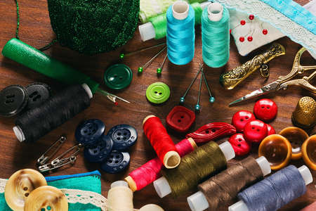 Thread reels, buttons, pins and other sewing materials and accessories in handicraft conceptのeditorial素材