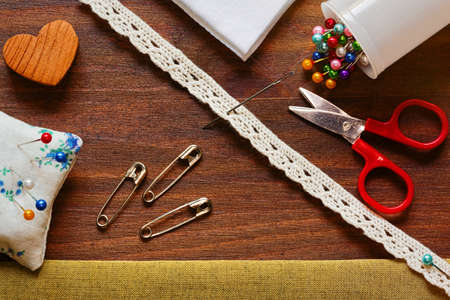 Handmade tailoring concept horizontal top view on wooden plank backgroundの写真素材