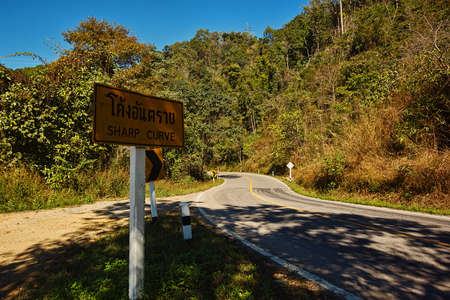 MAE HONG SON PROVINCE, THAILAND - JANUARY 14, 2017: Sharp curves on serpentine road with warning...