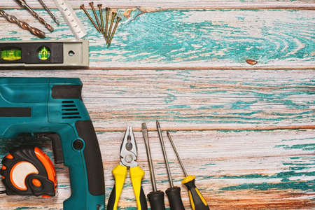 Different hand tools such as screwdrivers and pliers and hand perforator with drillers and screws,...