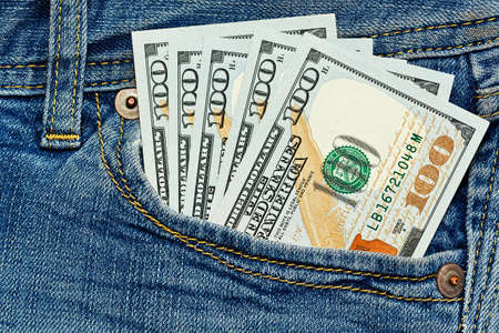 Few hundreds dollars in simple jeans pocket - close up capture - allowance or salary conceptの写真素材