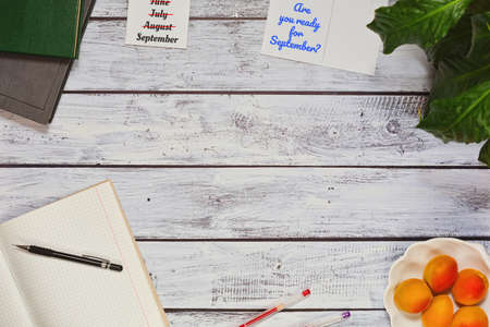 Beginning of autumn business or education concept - flat lay with office and study accessories, seasoning fruits and calendar countdown to first of septemberの写真素材