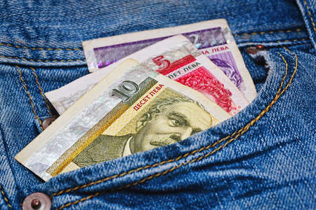 Some bulgarian bank notes - just around 8 euro or 10 US dollars - in worn blue classic jeans pocket...