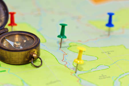 Colored pins in map symbolizing the route of journey in close-up capture with selective focus. No...