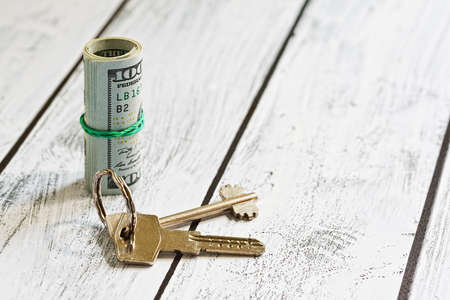 Renting or purchasing accommodation for US dollars currency- stack of one hundred bucks notes and a...