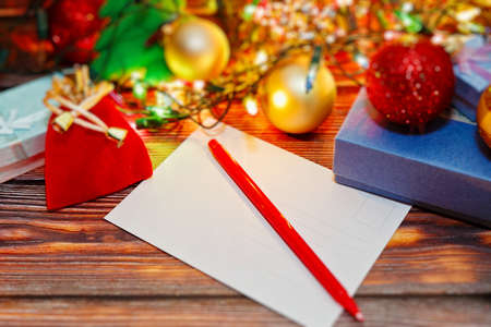 Winter holidays celebrations preparing and signing cards with congratulations for friends and relatives. Postcard and variety of Christmas and New Year decorations. Selective focus, close-up capture.の写真素材