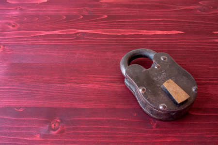 Old Fashioned Lock on a Red Wooden Backgroundの写真素材